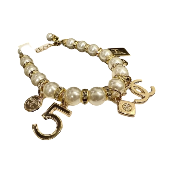 CHANEL Elegant Gold and Cream Charm Bracelet - Picture 1 of 2